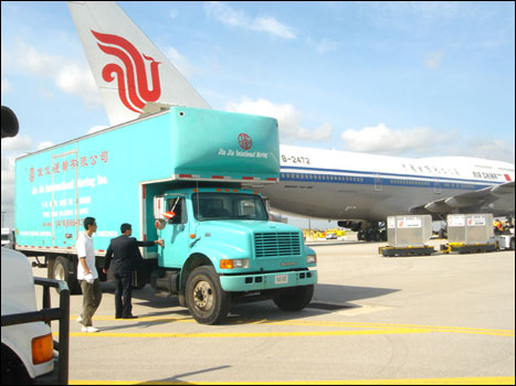 Moving Truck in front of Airplane 